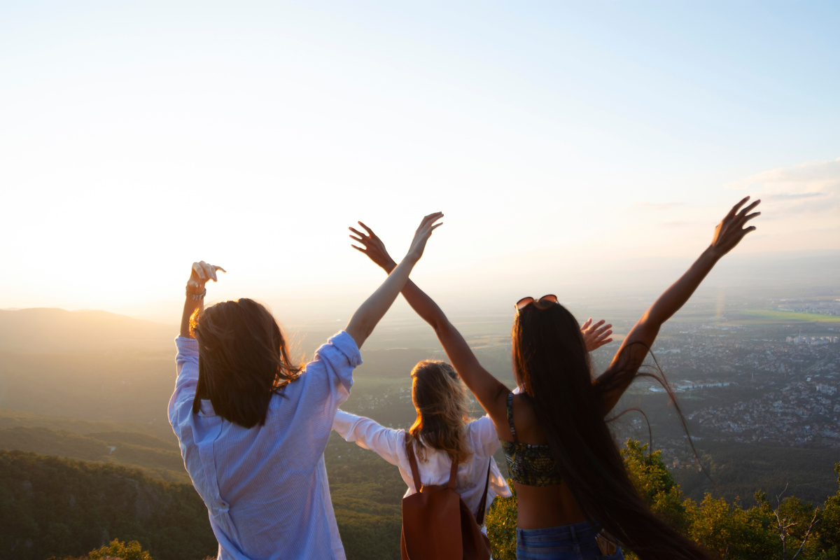 Women on mountain peak cliff